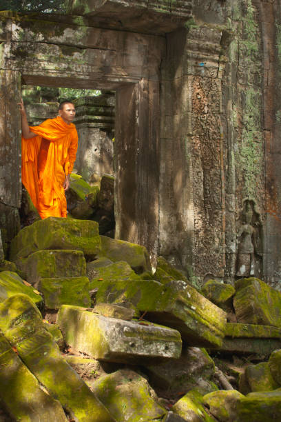 istock Monk at crumbling ruin at Angkor Wat 1267226535