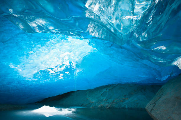 Inside a melting ice cave, Norway Ice cave inside Nigardsbreen Glacier forms during winter months, at  Jostedalsbreen, Europe's largest ice cap. Fjaerland, West Coast Fjords, Norway. icecap photos stock pictures, royalty-free photos & images