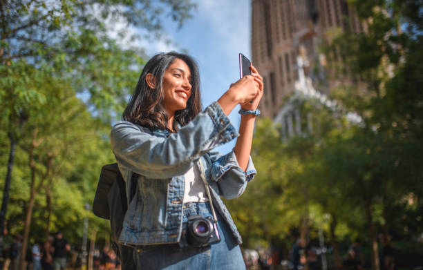 istock Happy Young Female Tourist Using Smart Phone in Barcelona 1267228445