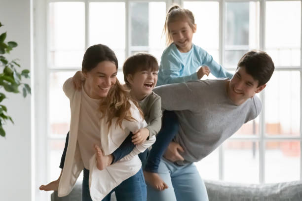 istock Young parents playing with energetic children at home. 1267228681