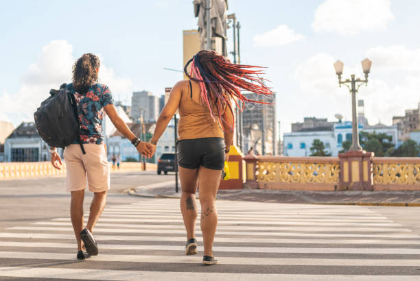 istock Couple holding hands crossing the crosswalk 1267230318
