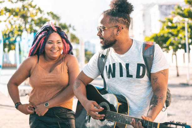 istock Young adults singing and playing guitar outdoors 1267230334