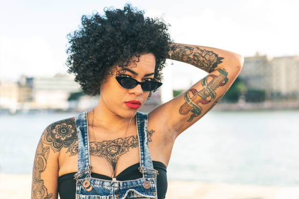istock Tattooed young woman posing at camera 1267230344