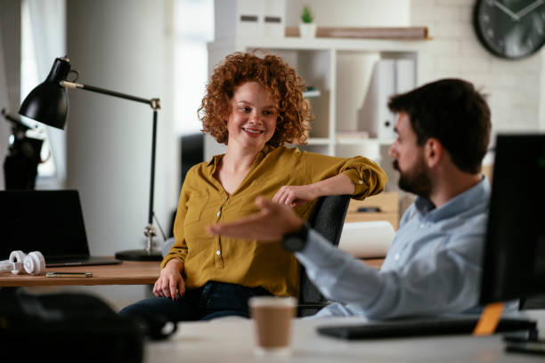 istock Businesswoman and businessman discussing work while drinking coffee. 1267230447