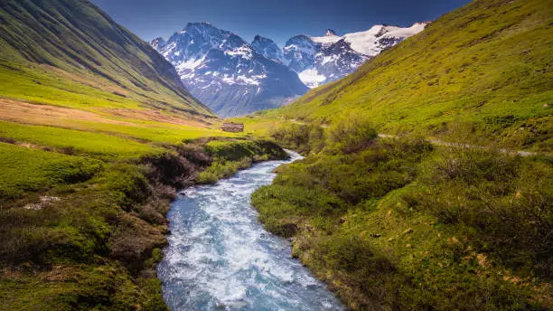 Photo of Idyllic alpine landscape with river at springtime in Vanoise, near Bonneval-sur-Arc – French alps