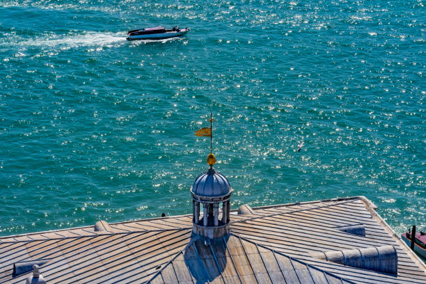 Colorful Grand Canal and Ferryboat Terminal with Motorboat Venice Italy.  This Ferryboat Terminal is at the St. Mark's Square with one of the fast motorboats in the background.