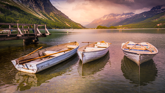 Alpine landscape and wooden boats on Silvaplana lake at sunset – Engadine, Switzerland