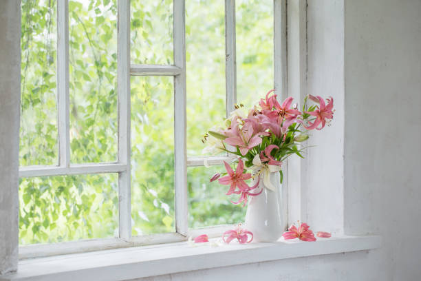istock summer flowers in vase on white windowsill 1267247289