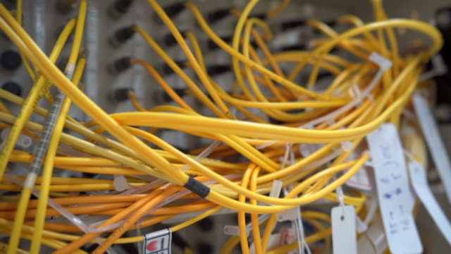 Fiber optic cable connected to enclosure box in a technology data center room for high speed communication