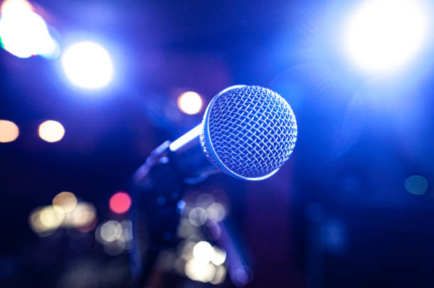 istock round microphone in the rays of multi-colored lamps on the concert stage 1267250903