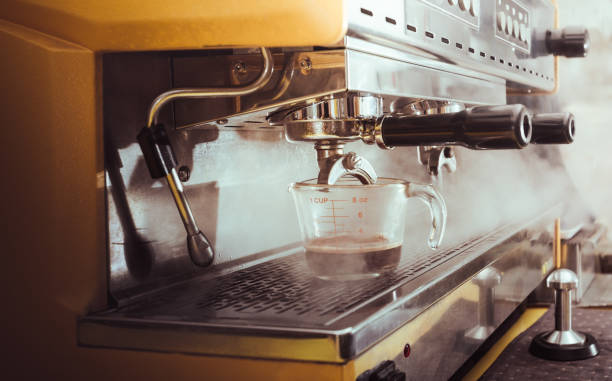 istock Barista using coffee machine for making coffee in the cafe, Coffee Preparation Service Concept 1267251742