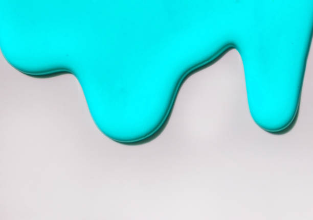 istock Turquoise paint spreads against a white background. Copy space. 1267252609