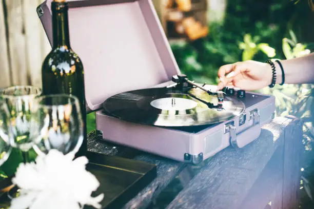 Photo of black vintage vinyl disk span by record player machine