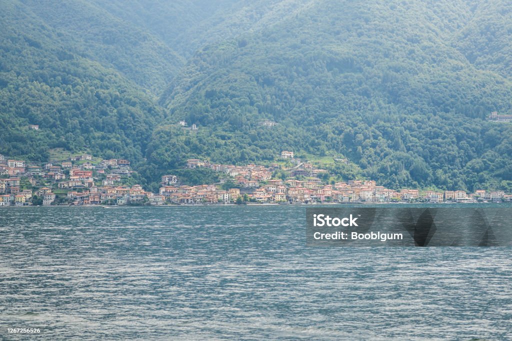Panorama at Lake Como. Lezzeno Town on Background. Hills Covered Green Forest. Panorama at Lake Como. Lezzeno Town on Background. Hills Covered Green Forest. Italy. Architecture Stock Photo