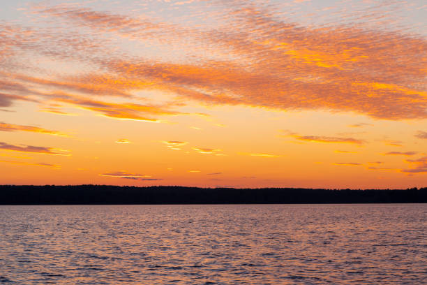 istock Water surface. View of a Sunset sky background. Dramatic gold sunset sky with evening sky clouds over the sea. View of a Crystal clear sea water texture. Landscape. Small waves. Water reflection 1267259057