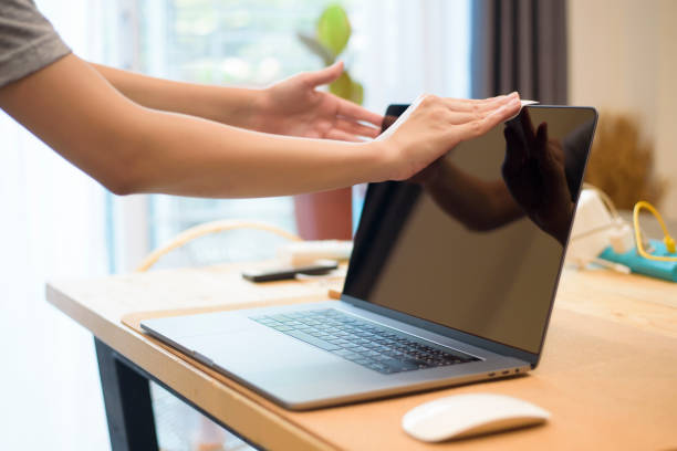 istock woman is cleaning laptop by alcohol spray 1267259964