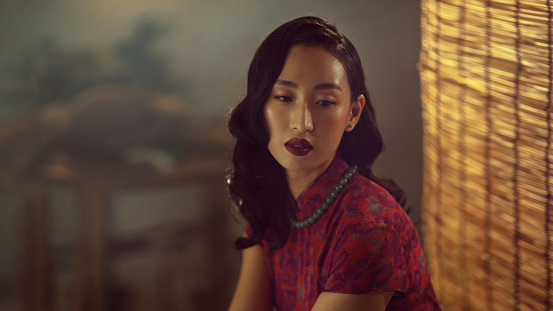 Portrait of a beautiful asian lady in traditional chinese cheongsam
