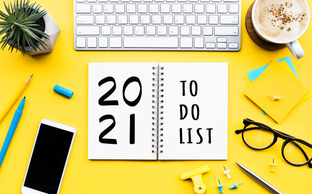istock 2021 new year with to do list  text on notepad with office accessories 1267267095