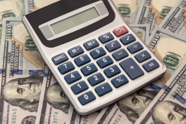 istock save money calculator and dollar bills 1267268409