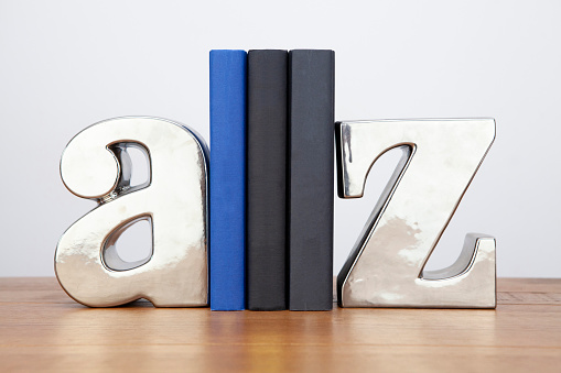 Straight on view of three books between silver coloured A Z bookends