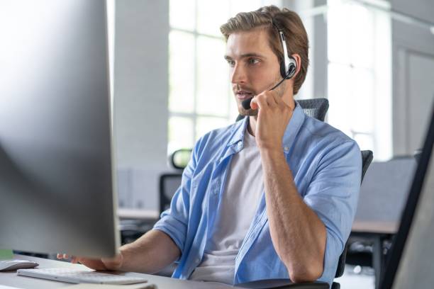 istock Young handsome male customer support phone operator with headset working in call center 1267270692