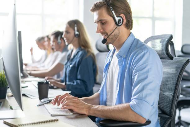 istock Young handsome male customer support phone operator with headset working in call center 1267270707