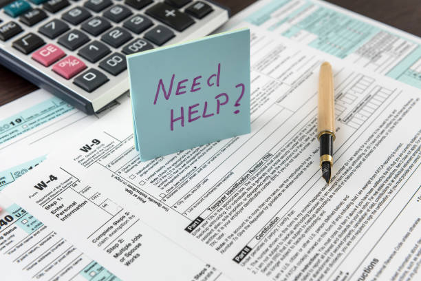 istock Tax form, pen and calculator at office desk 1267270761