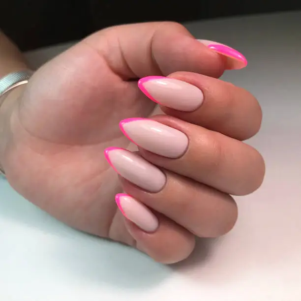 French manicure on the nails.Manicure gel nail polish. Spa and Manicure concept. Female hands with french manicure.