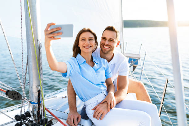 istock Spouses On Cruise Yacht Making Selfie Standing On Deck Outside 1267272166