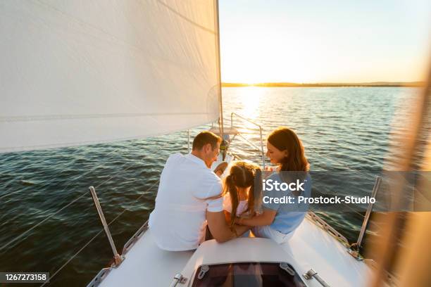 Family Yacht Sailing Parents And Daughter Sitting On Deck Backview Stock Photo - Download Image Now
