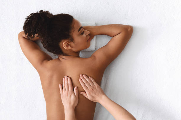 istock Black lady enjoying relaxing body massage at spa 1267273177
