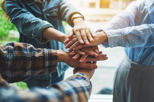 istock business team standing and joining their hands together in office 1267273232