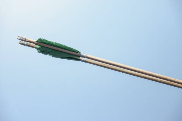 istock Old green wooden arrow on a beautiful blue background. 1267273258