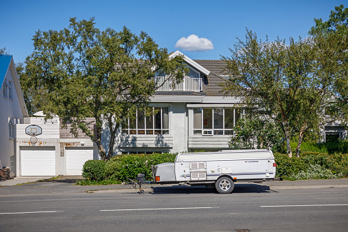 Reykjavik, Iceland, July 6, 2020: Modern residential building with a trailer in front in the suburbs of Reykjavik, the capital of Iceland