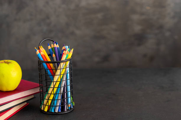 istock Pencils , apple and books on black background Back to school and studying concept 1267274751