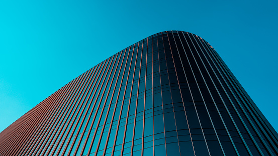 Image taken of a glass building, shown from the bottom, looking upwards, showing only a portion of great significance.