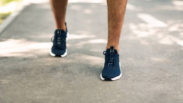 istock Closeup view of black runner on jogging track outside 1267274969