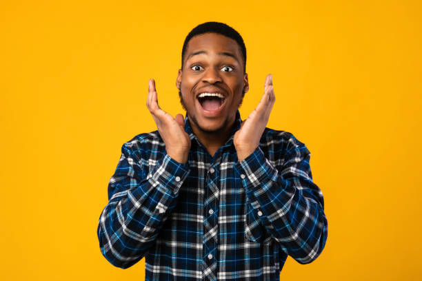 istock Excited Black Man Shouting Holding Hands Near Face In Studio 1267275306