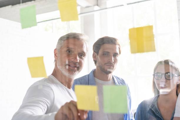 istock Business people meeting at office and use post it notes to share idea. Brainstorming concept. Sticky note on glass wall 1267277965
