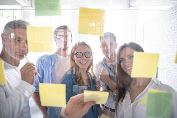 istock Business people meeting at office and use post it notes to share idea. Brainstorming concept. Sticky note on glass wall 1267277971