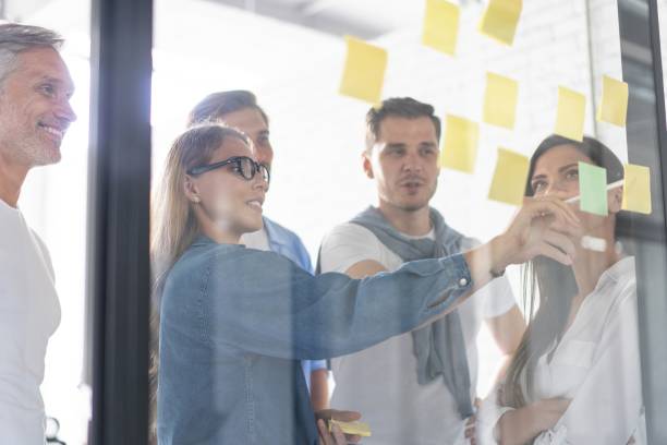 istock Business people meeting at office and use post it notes to share idea. Brainstorming concept. Sticky note on glass wall 1267277976