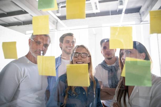 istock Business people meeting at office and use post it notes to share idea. Brainstorming concept. Sticky note on glass wall 1267277983
