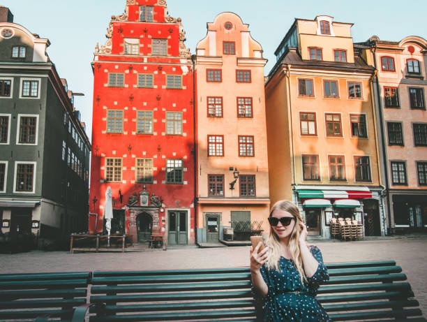 Woman tourist in Stockholm city Gamla Stan traveling lifestyle girl using smartphone blogging Europe trip vacations Woman tourist in Stockholm city Gamla Stan traveling lifestyle girl using smartphone blogging Europe trip vacations stortorget photos stock pictures, royalty-free photos & images