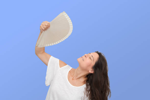 istock Attractive Spanish middle-aged brunette woman making expressive gestures. slicing because of the heat 1267278723