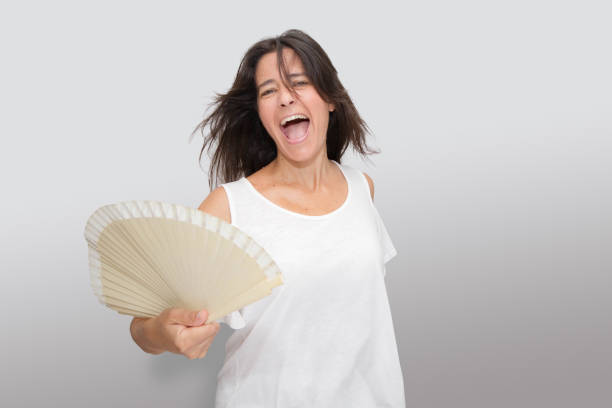 istock Attractive Spanish middle-aged brunette woman making expressive gestures. slicing because of the heat 1267278726