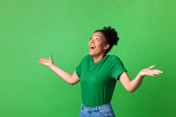 istock Woman with opened arms looking up at copy space 1267278770