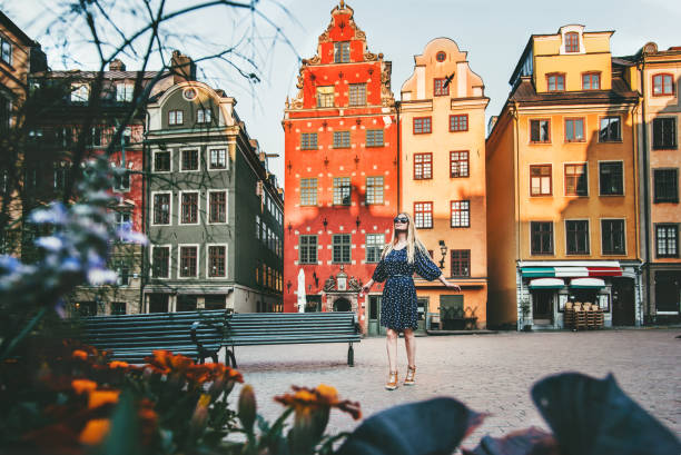Young woman traveling in Stockholm sightseeing Gamla Stan Stortorget architecture lifestyle summer vacations in Sweden Young woman traveling in Stockholm sightseeing Gamla Stan Stortorget architecture lifestyle summer vacations in Sweden stortorget stock pictures, royalty-free photos & images