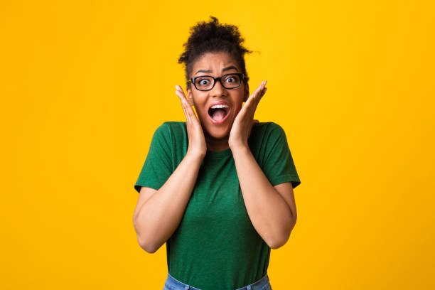 istock Surprised afro woman in specs screaming at studio 1267279903