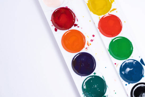 istock Top view of paintbrushes palette on white paper background 1267280017