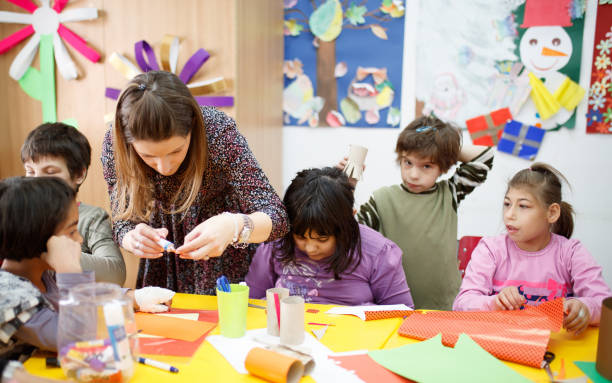 istock Cheerful school children with special needs sitting at a desk in primary school class 1267280072